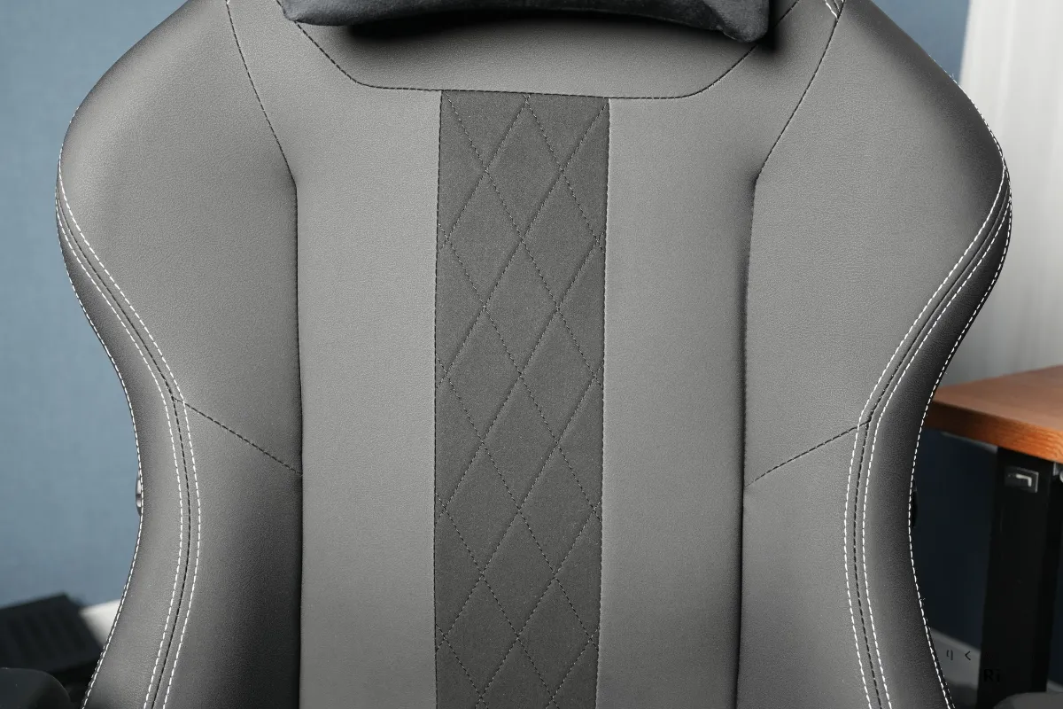 Boulies Master Rex の背もたれクッションのアップ。グレー寄りに調整されたPUレザーと中央のスエード生地、ダイヤモンドステッチが高級感を演出している