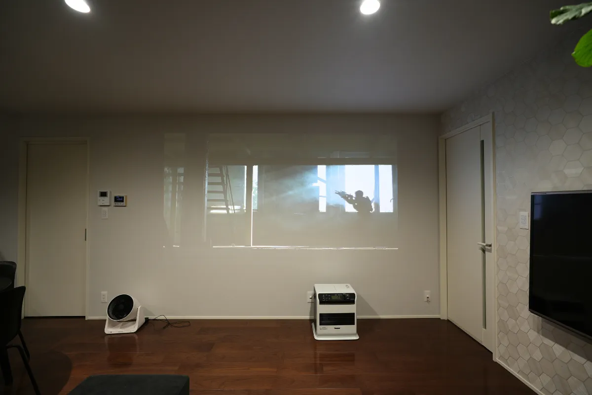 明るい室内で壁に映像を投影した際の見え方を示した写真
